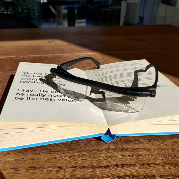 adjustable glasses on a book